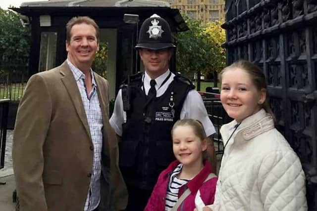 PC Keith Palmer poses for a picture with Andrew Thorogood and his daughters Alexsandra and Georgia outside the Houses of Parliament in October 2016. Picture: SWNS