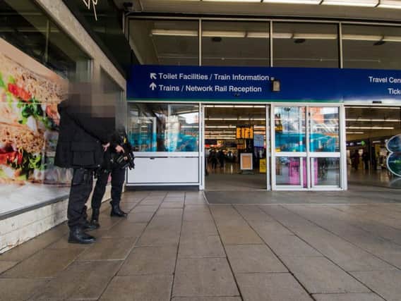 Armed police outside Leeds train station yesterday.