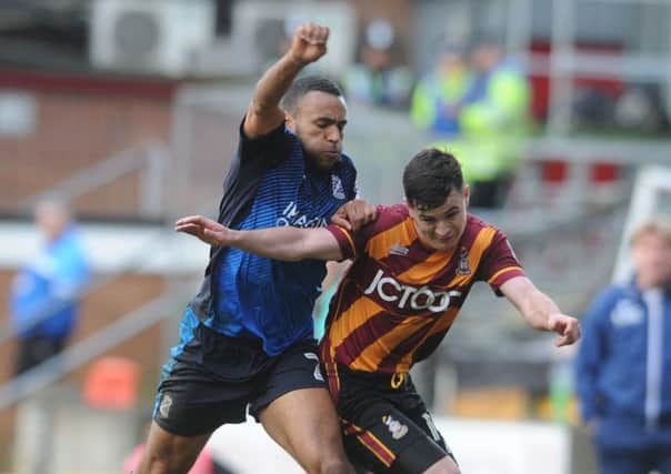 Bradford City's Josh Cullen takes on Swindon captain Nathan Thompson. (Picture: Tony Johnson)