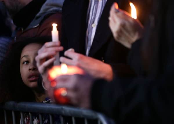 A young girl looks as members of the public hold candles during the candlelight vigil in Trafalgar Square, London to remember those who lost their lives in the Westminster terrorist attack. PRESS ASSOCIATION Photo.