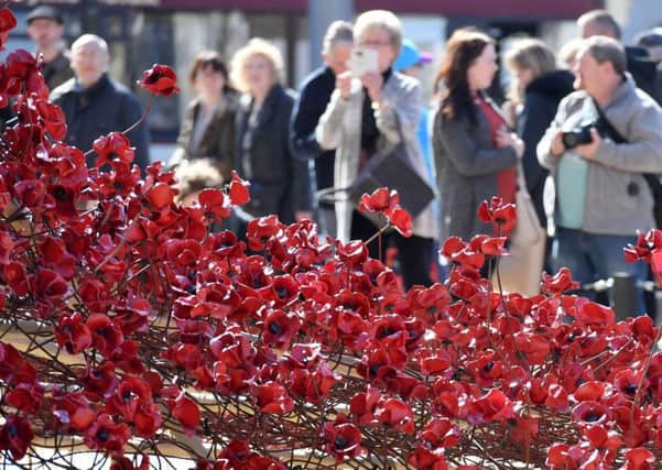 The poppy sculpture Weeping Window by artist Paul Cummins and designer Tom Piper is unveiled outside the Maritime Museum in Hull. Anthony Devlin/PA Wire