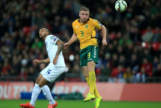 FAMILIAR FACES: England's Theo Walcott (right) and Lithuania's Georgas Freidgeimas battle for the ball when the two sides met during a Euro 2016 qualifier at Wembley two years ago. Picture: Nick Potts/PA.