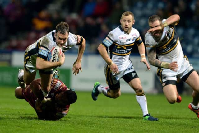 Danny McGuire is held in full flight by the 
Huddersfield Giants defence. Picture: Bruce Rollinson