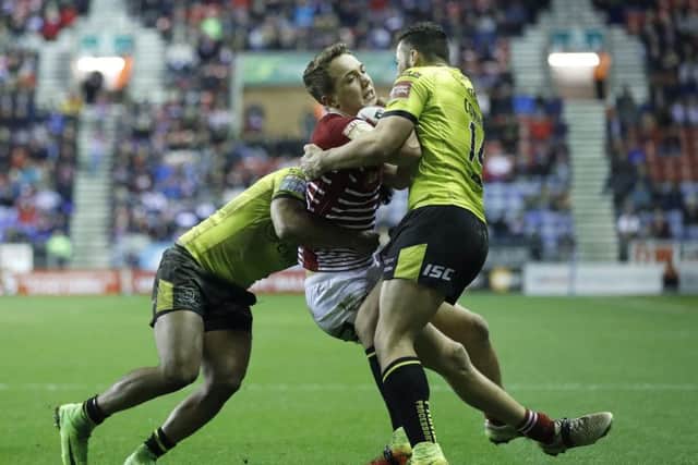Wigan Warriors' Liam Forsyth is tackled by Hull FC's Albert Kelly (left) and Jake Connor. Picture: Martin Rickett/PA.