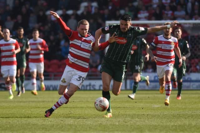 Doncaster Rovers Alfie May  takes on Plymouth Argyles Gary Miller yesterday at Keppmoat Stadium (Picture: Matt McLennan).