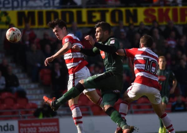 John Marquis heads towards goal for Doncaster Rovers against Plymouth