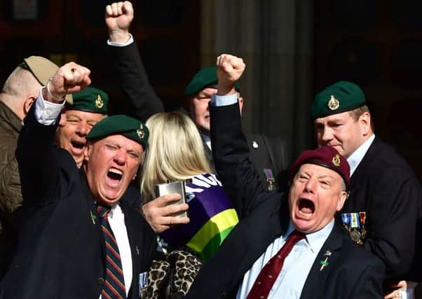 Supporters of Alexander Blackman celebrate outside the Royal Courts of Justice in London.