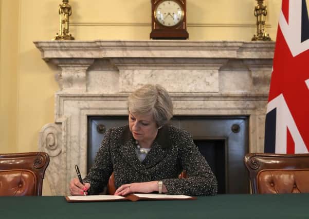 Theresa May signs the letter to invoke Article 50.