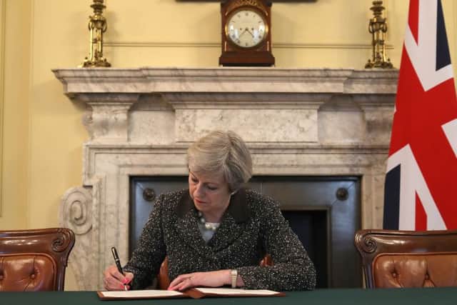 Prime Minister Theresa May in the cabinet signing the Article 50 letter