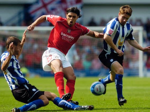 Barnsley's Anderson Silva is blocked by Sheffield Wednesday's Tommy Spurr and James O'Connor