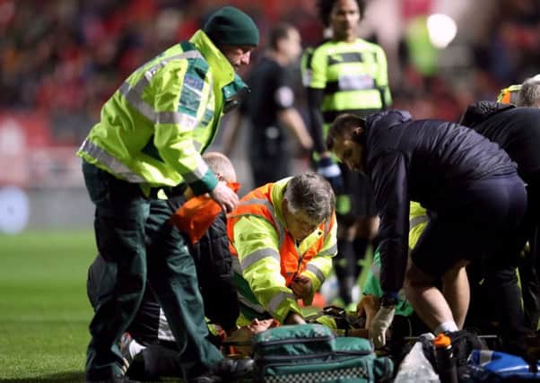 Huddersfield Town's Jonathan Hogg receives treatment on the pitch at Bristol City for his neck injury (Picture: Adam Davy/PA Wire).