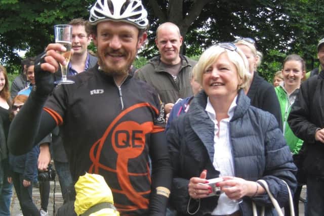 Mike Hall with his mother, Pat, after he won a round-the-world bike race in 2012