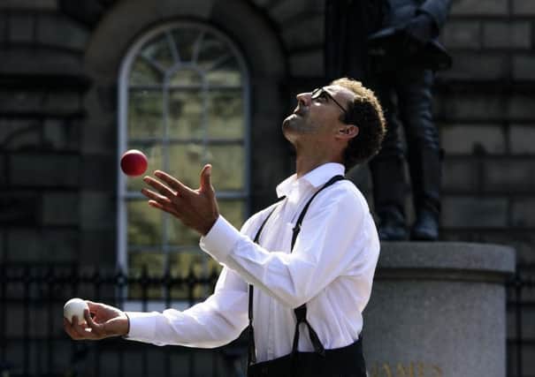 Francois the Juggler practicing behind Saint Giles Cathedral in Edinburgh.