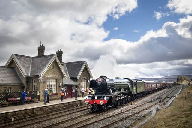 The Flying Scotsman passes Ribblehead station in the Yorkshire Dales.