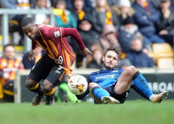 Bradford City winger Mark Marshall is dragged down by Swindon Towns John Goddard (Picture: Tony Johnson).