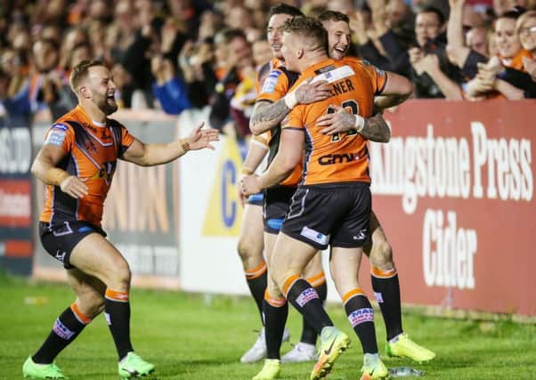 Castleford Tigers' Adam Milner (right) celebrates scoring a try with his team-mates.