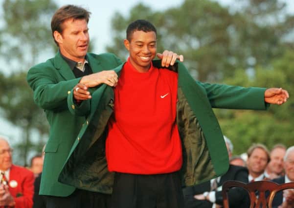 MEMORABLE MOMENT: Tiger Woods is given the victor's green jacket by previous winner Nick Faldo after winning The Masters at August back in April 1997.