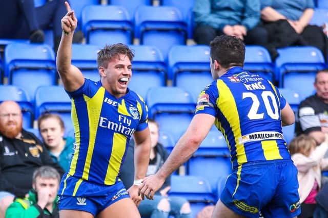 Warrington's Matty Russell, left, celebrates his try with Toby King. Picture by Alex Whitehead/SWpix.com