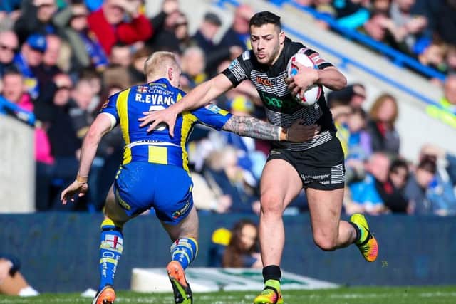 Hull FC's Jake Connor is tackled by Warrington's Rhys Evans. Picture by Alex Whitehead/SWpix.com