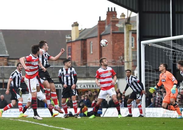 Doncaster Rovers' John Marquis scores his side's second goal of the match against Grimsby Town. Picture: Jon Buckle/PA.