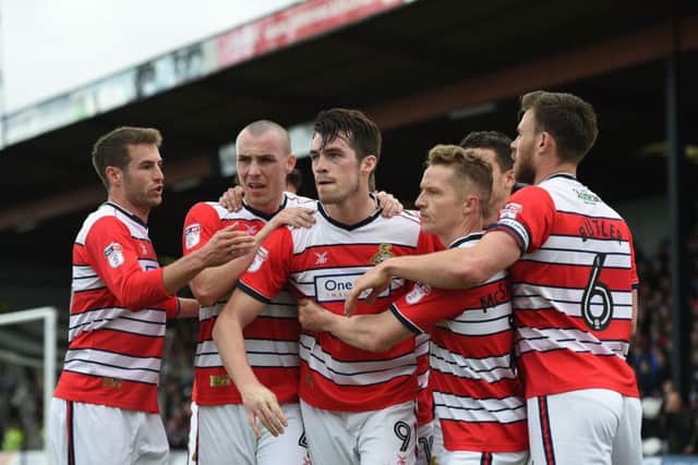 Doncaster Rovers' John Marquis is congratulated by his teammates after scoring his sides second goal. Picture: Jon Buckle/PA.