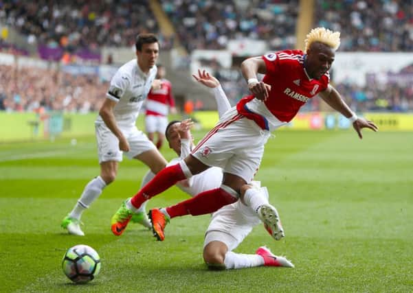 Middlesbroughs Adama Traore tumbles to the floor under a challenge from Swansea Citys Martin Olsson (Picture: David Davies/PA).