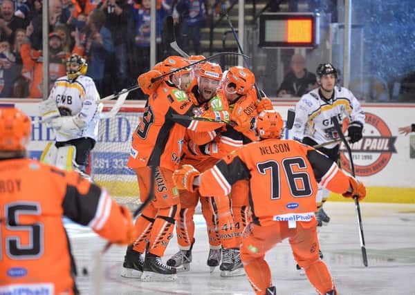 Guillaume Desbiens is mobbed by team-mates after his overtime winner completed an amazing fightback against rivals Nottingham Panthers. Picture: Dean Woolley