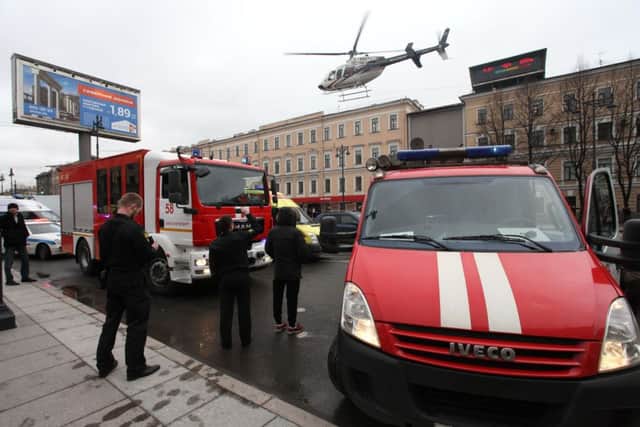 A helicopter flies over the fire trucks after an explosion at Tekhnologichesky Institut subway station in St.Petersburg