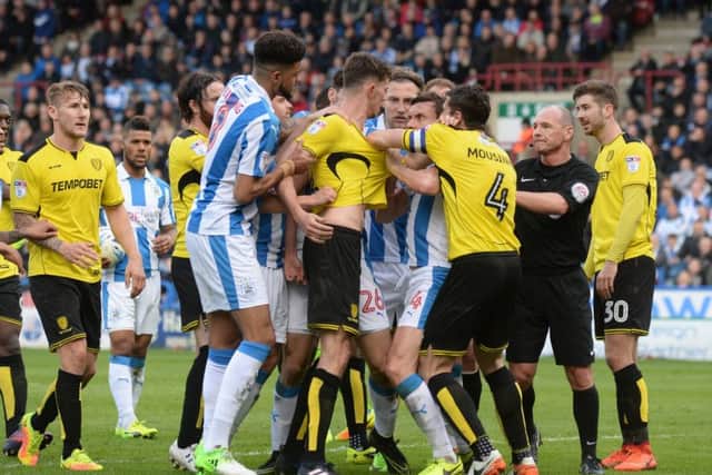 FLASHPOINT: Dean Whitehead and Tom Flanaghanclash at the John Smith's Stadium, with the Huddersfield Town man getting a second yellow card.  Picture: Bruce Rollinson