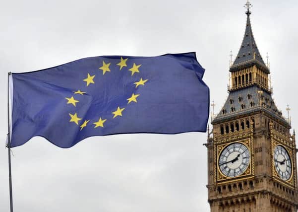 An EU flag flies in front of the Houses of Parliament. By Victoria Jones/PA Wire