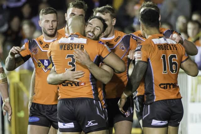 Castleford's players celebrate a try in their victory over Huddersfield Giants.
