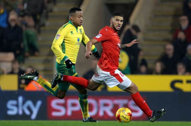 Norwich City's Martin Olsson battles for the ball and Huddersfield Town's Nakhi Wells at Carrow Road in December 2016. Picture: Chris Radburn.