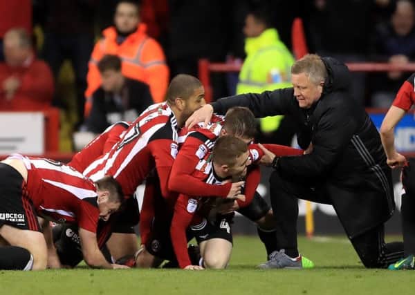 Sheffield United's John Fleck (left)celebrates scoring his side's second goal of the game with teammates, and manager Chris Wilder during the Sky Bet League One match at Bramall Lane, Sheffield. (Picture: Tim Goode/PA Wire)