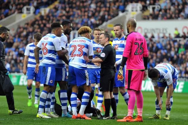 Reading's players confront the referee over the incident