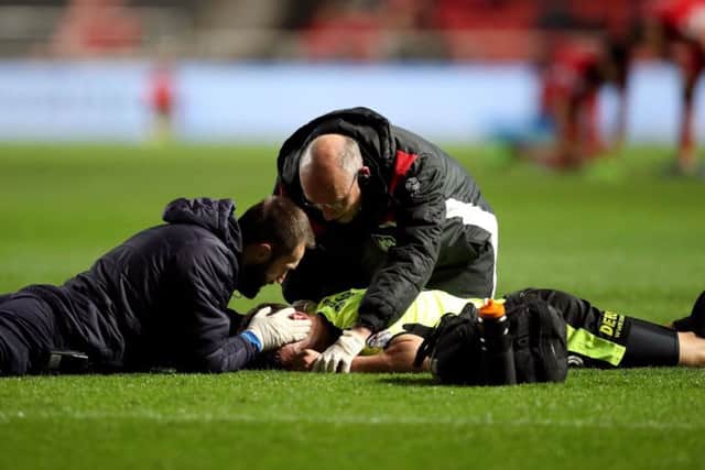 Huddersfield Town's Jonathan Hogg receives treatment on the pitch for an injury during the Sky Bet Championship match at Ashton Gate, Bristol. (Picture: Adam Davy/PA Wire)