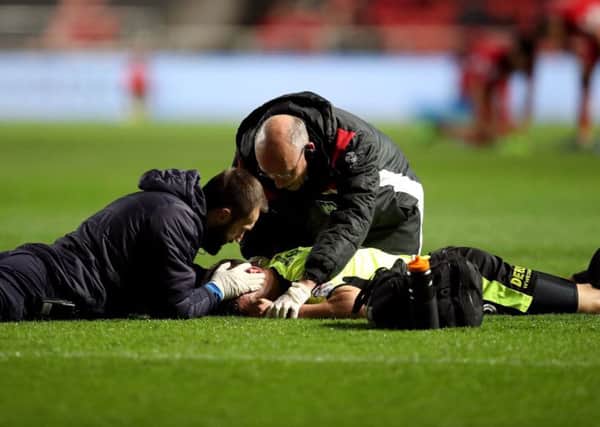 Huddersfield Town's Jonathan Hogg receives treatment on the pitch for an injury during the Sky Bet Championship match at Ashton Gate, Bristol. (Picture: Adam Davy/PA Wire)