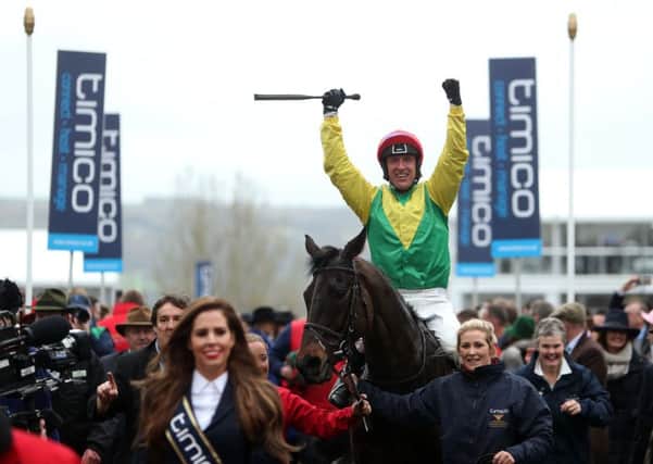 Jockey Robbie Power celebrates after his winning ride on Sizing John in the Timico Cheltenham Gold Cup Chase.