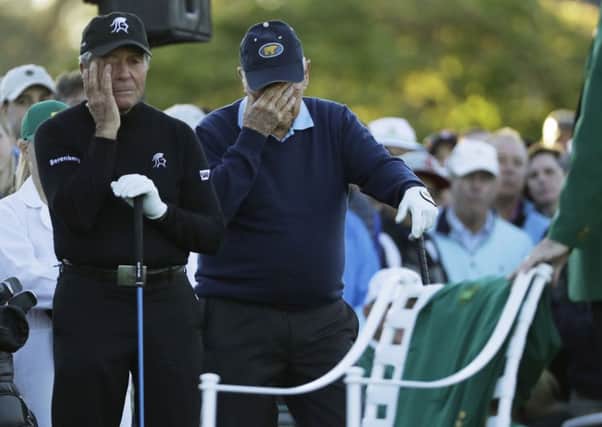 Jack Nicklaus, right, and Gary Player wipe away tears as a chair on the first tee is draped with a green jacket to honour the late Arnold Palmer before the start of the first round of the Masters, at Augusta. The trio were golfs Big Three of the Sixties (Picture: David J Phillip/AP).