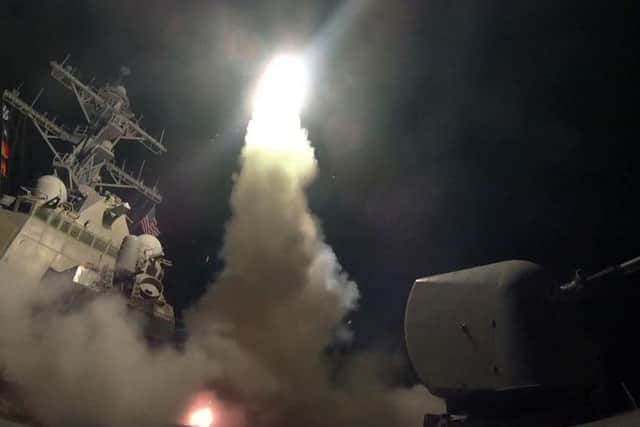This image provided by the U.S. Navy shows the guided-missile destroyer USS Porter (DDG 78) launching a tomahawk land attack missile in the Mediterranean Sea. The United States blasted a Syrian air base with a barrage of cruise missiles in retaliation for this week's gruesome chemical weapons attack against civilians.