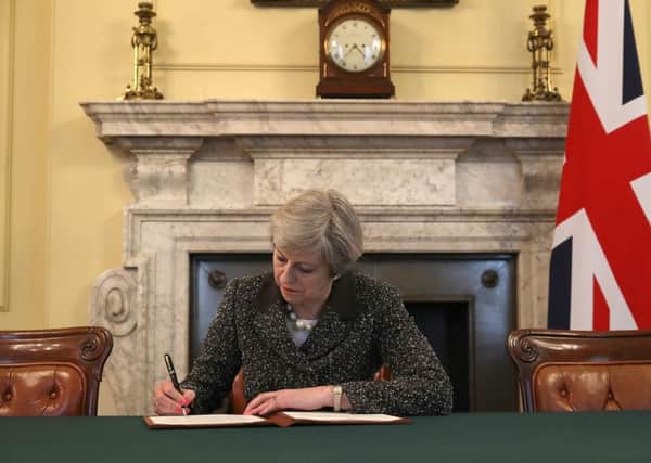 Prime Minister Theresa May in the cabinet signs the Article 50 letter, as she prepares to trigger the start of the UK's formal withdrawal from the EU.
