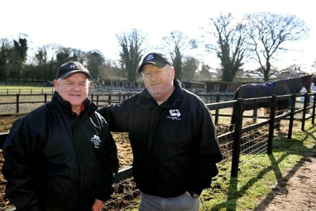Racehorse trainer Brian Ellison (left) at his stables near Norton with the owner of Definity Red, Phil Martin. (Picture: Gary Longbottom)