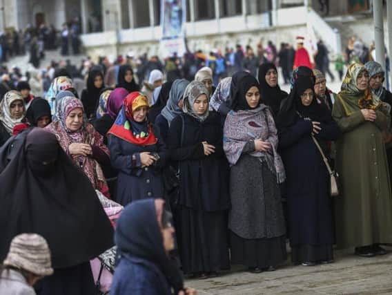 Women hold a special prayer for the victims of the suspected chemical attack in Idlib, Syria, following a prayer in Istanbul, Friday, April 7