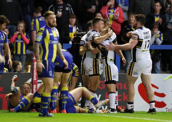 OPENING SALVO: Tom Briscoe celebrates his opening try for Leeds Rhinos at Warrington Wolves last night. Picture: Bruce Rollinson.