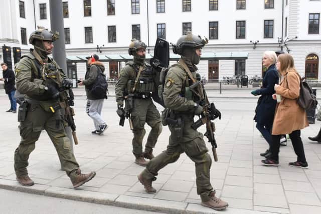 Armed police patrol outside the central station in Stockholm. Picture: Jessica Gow/ TT News Agency via AP