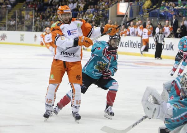 Andreas Valdix (12) battles for possession against BElfast at the NIC. Picture courtesy of EIHL.
