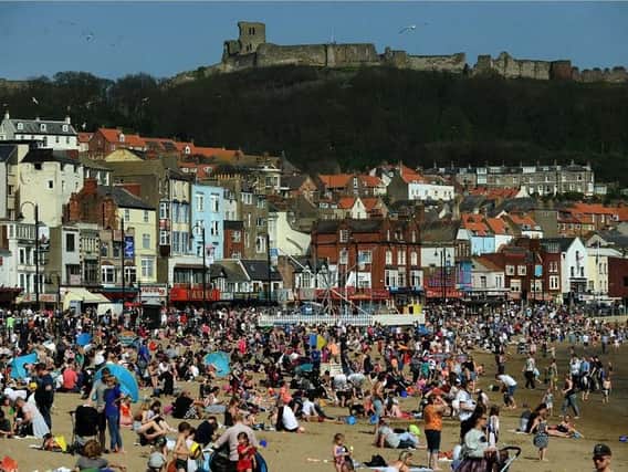 Crowds pack onto the South Bay in Scarborough as warm weather bathes the UK. Picture: Jonathan Gawthorpe