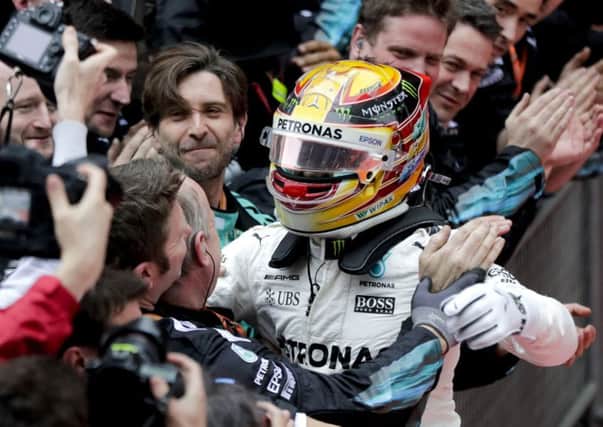 Response: Lewis Hamilton takes the adulation after his start-to-finish victory in the Chinese Grand Prix. (Picture: AP)