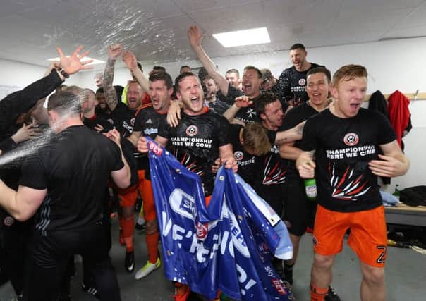 relief and jubilation: Sheffield United players celebrate clinching promotion with a come-from-behind victory at Northampton that sealed their place back in the Championship. (Picture: Sportimage)