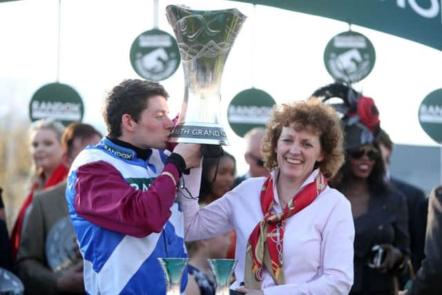 Jockey Derek Fox and trainer Lucinda Russell celebrate with the trophy after winning the Randox Health Grand National on One For Arthur.