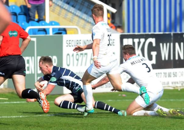 Featherstone Rovers' Cory Aston scores a try.